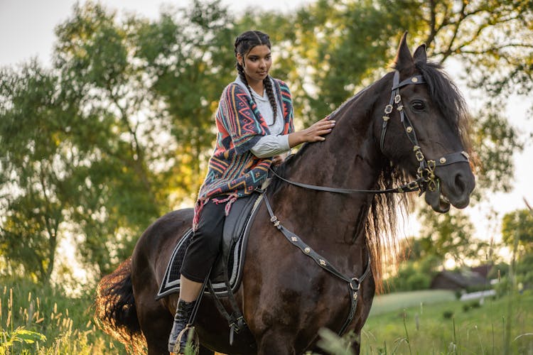 Photo Of A Woman With Pigtails Riding A Horse