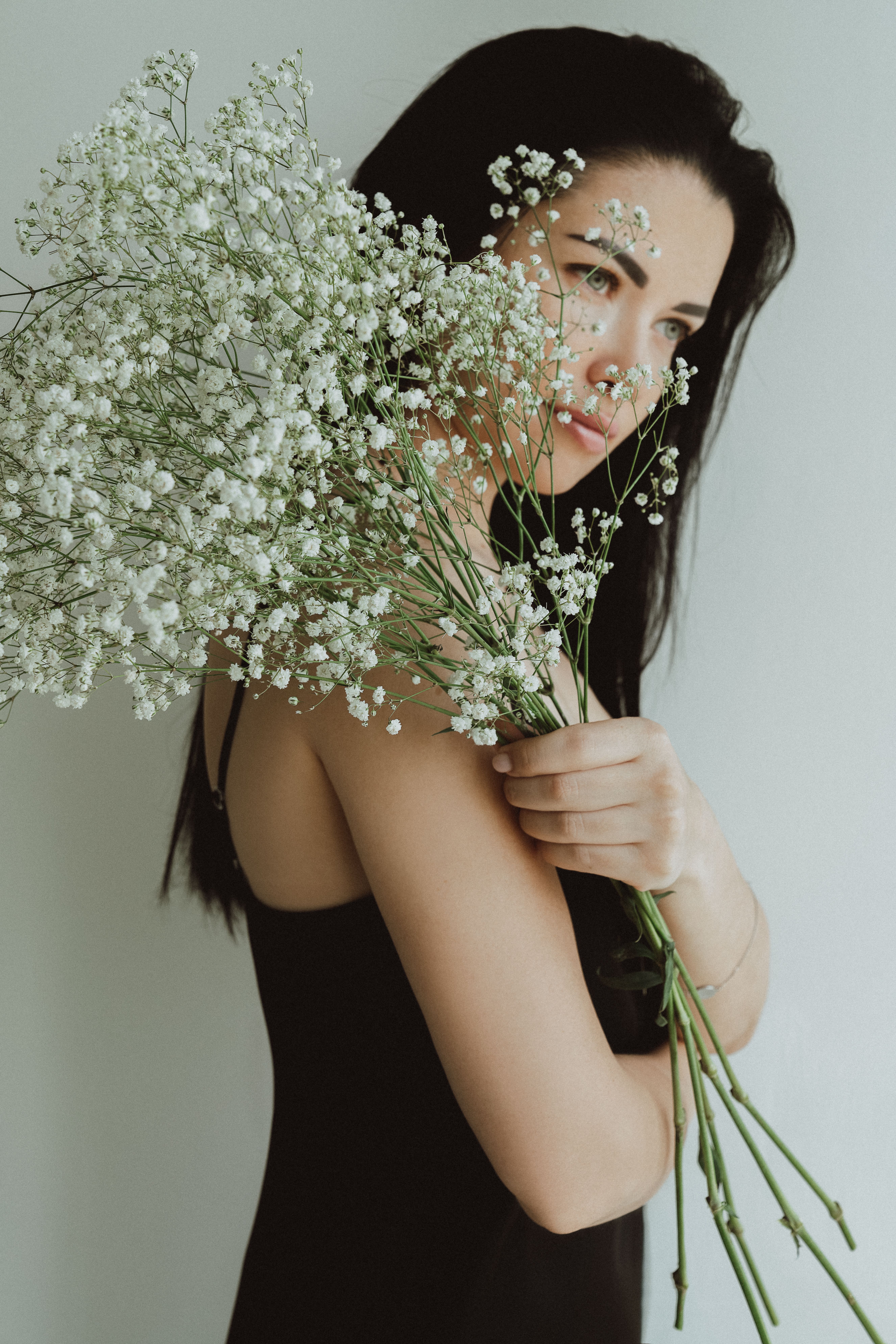 Close-Up Shot of a Woman Holding White Flowers · Free Stock Photo