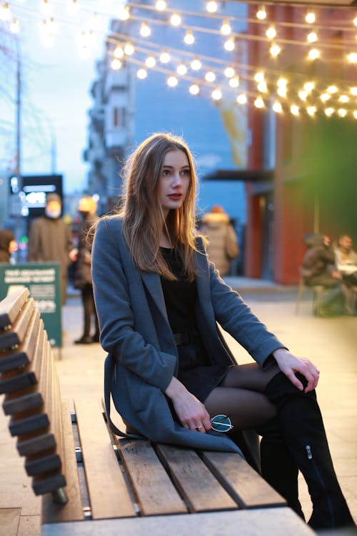 Beautiful Woman in Gray Coat Sitting on Wooden Bench