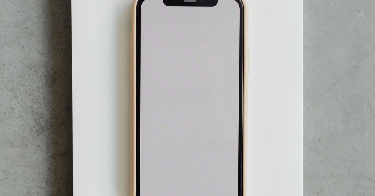 Notepad Type Cell Phones A Smartphone on a Notepad · Free Stock Photo
