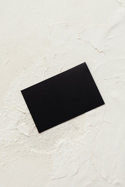 Photograph of a Black Card on a White Surface