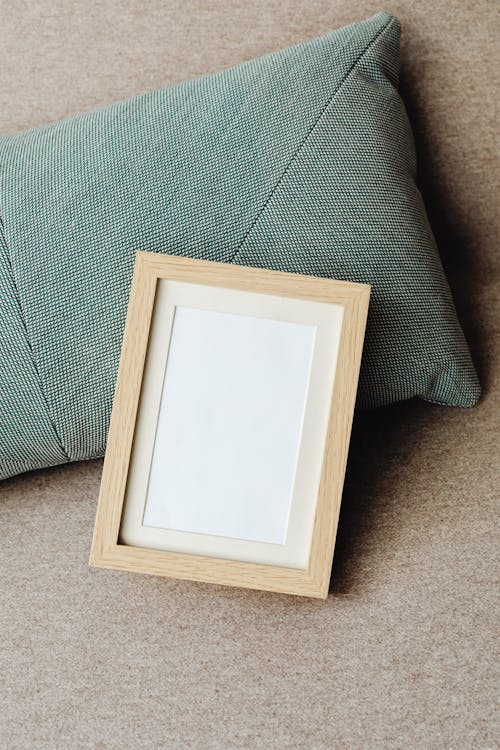 Photo of an Empty Picture Frame on a Pillow