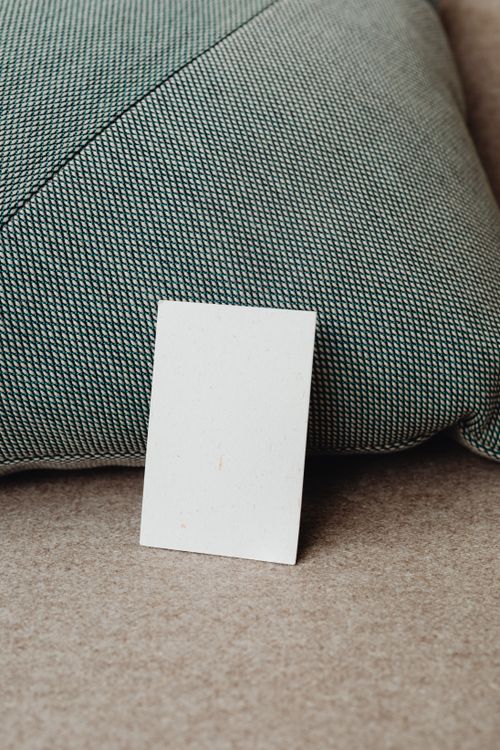 Free Elegant blank card resting against a textured cushion, ideal for design mockups and presentations. Stock Photo