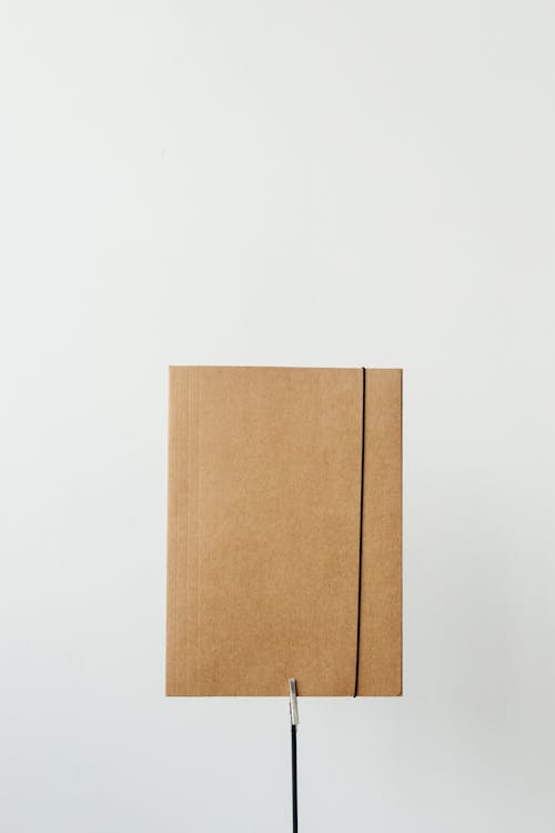 Close-Up Shot of a Brown Cardboard Folder on white Background
