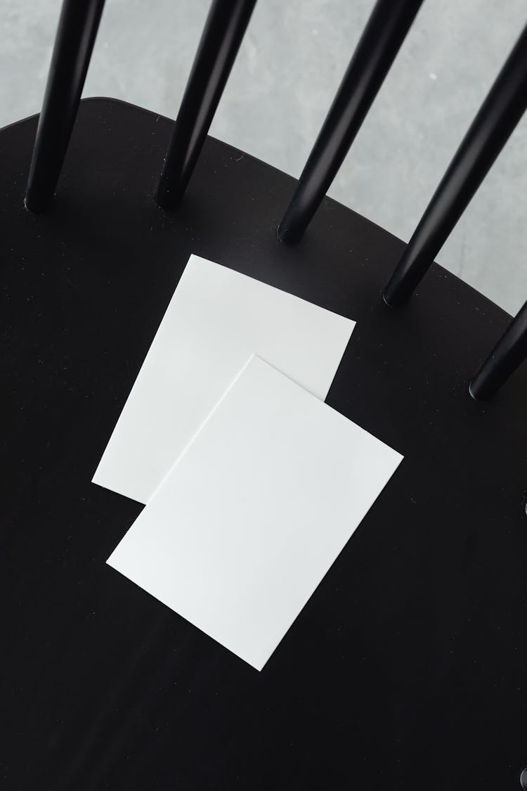 Empty White Paper Sheets On A Black Chair 