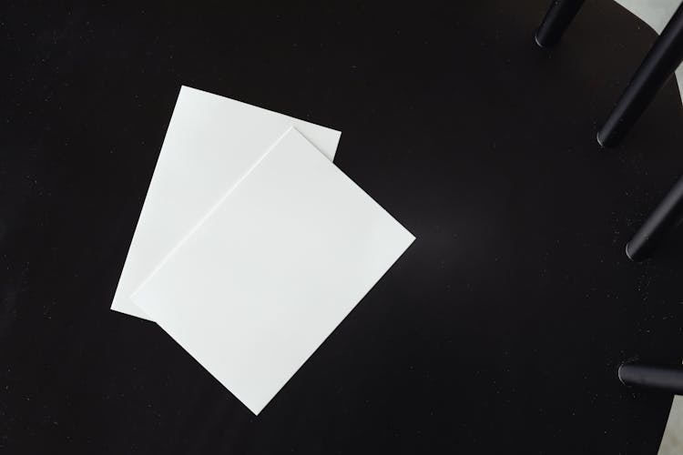 Empty White Paper Sheets On A Black Chair 