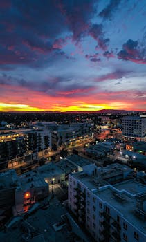 A breathtaking aerial view of Los Angeles at sunset, showcasing vibrant skies over city architecture.
