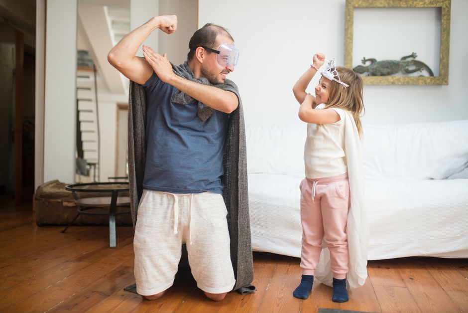 father and 8 year old daughter doing fun activity