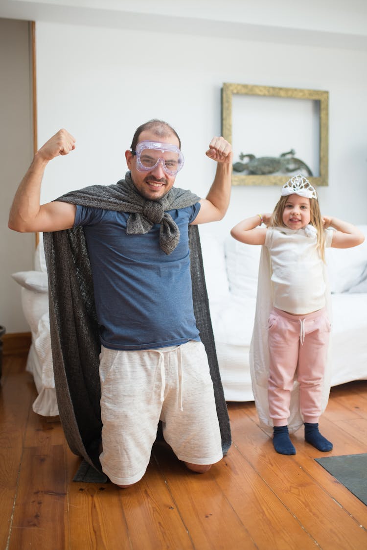 A Man And A Girl Wearing Capes Playing Heroes 