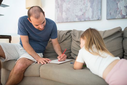 Man in Blue Crew Neck T-shirt Sitting on Gray Couch