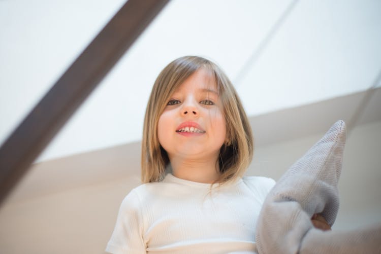 A Girl Holding A Pillow