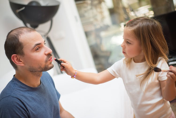 Girl Applying Lipstick On A Man