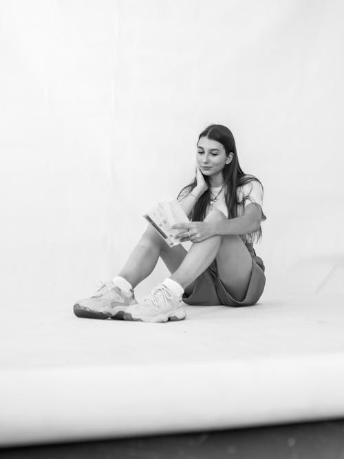 Woman Wearing T-shirt Sitting on the Floor