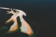 An Aerial View of a Coastal Landform Projecting Out to the Sea