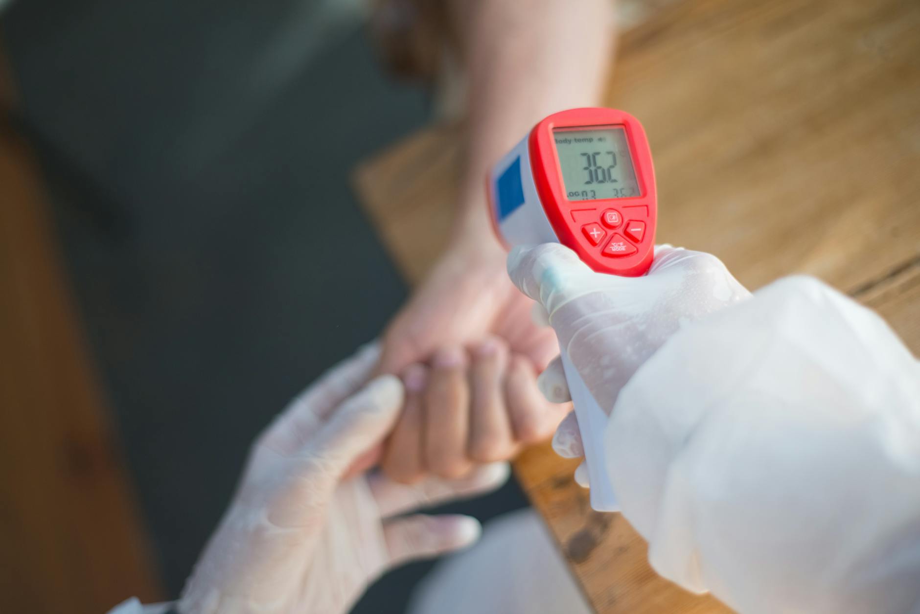 https://www.pexels.com/photo/a-person-holding-an-infrared-thermometer-8949825/