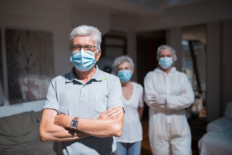 Elderly Man Wearing A Face Mask With His Arms Crossed