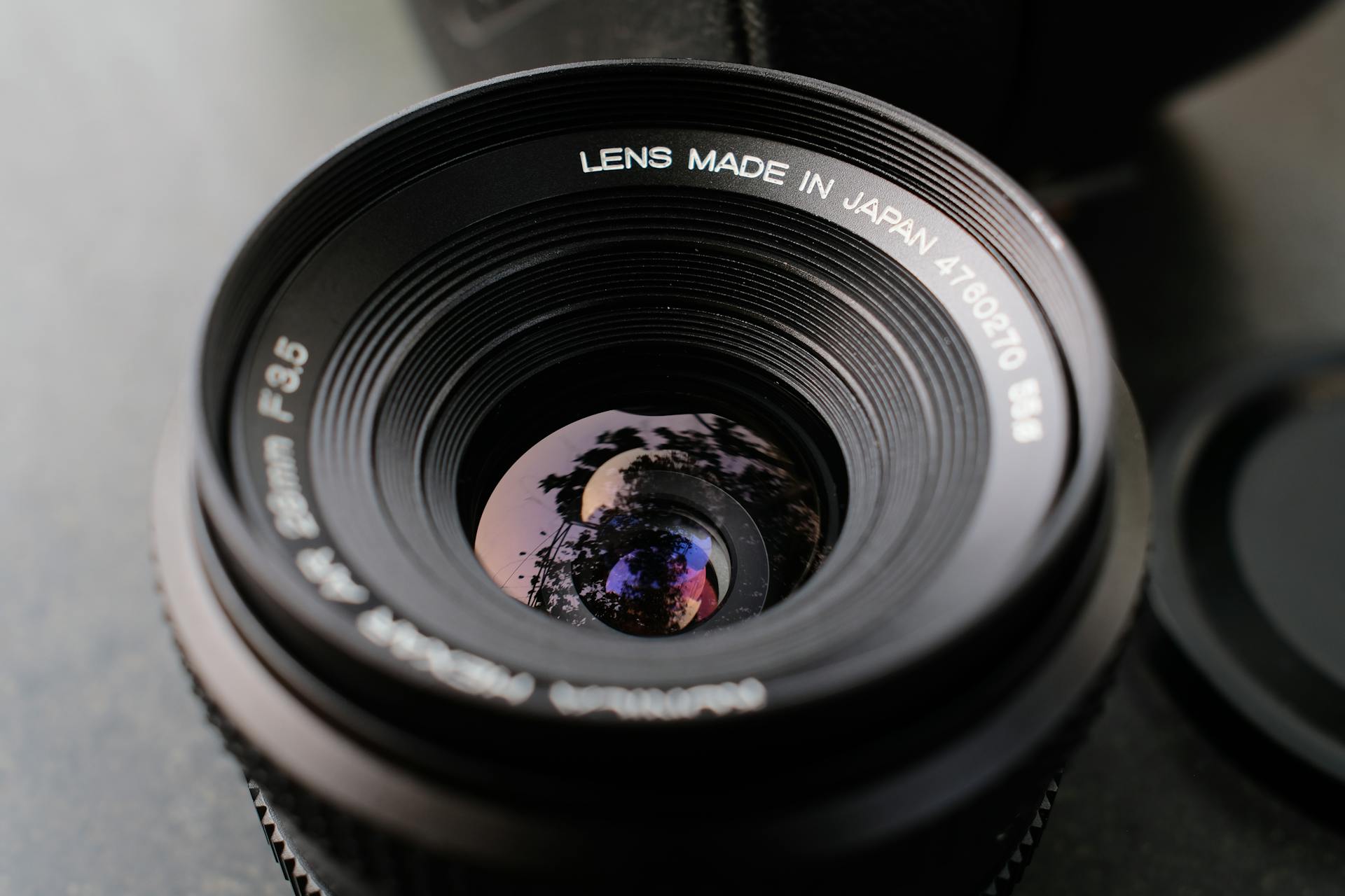 Detailed image of a vintage camera lens showcasing precise reflections and craftsmanship.