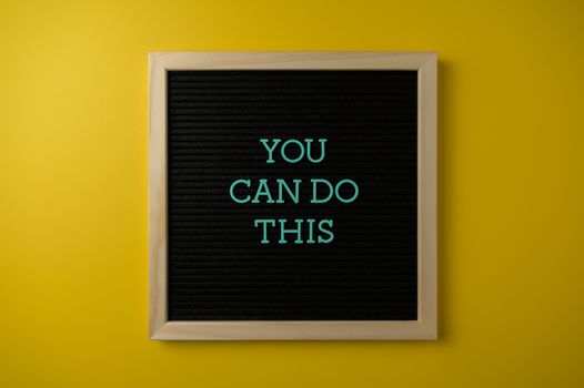 Inspirational message 'You Can Do This' displayed on a blackboard with a bold yellow backdrop.