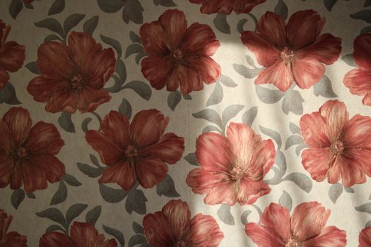 Beautiful close-up of red floral pattern fabric with textured design.