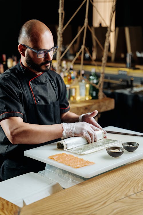 Chef Preparing Sushi Roll