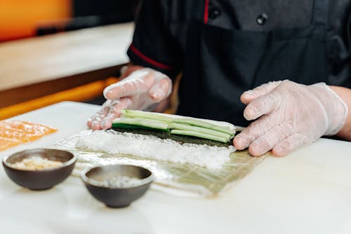 Cook Preparing a Mango Sushi Roll