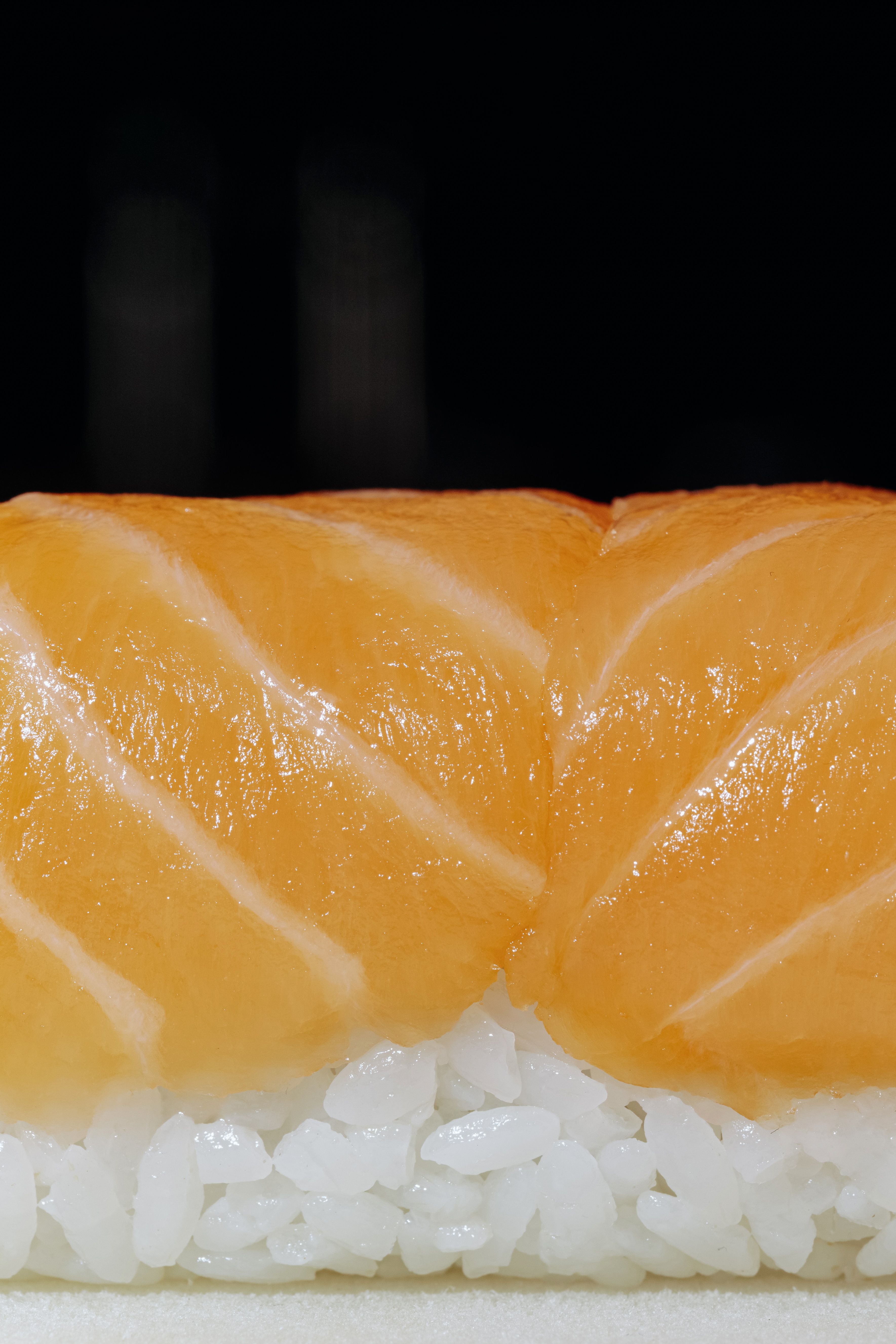 Detailed photo of fresh salmon nigiri, highlighting vibrant colors and texture.