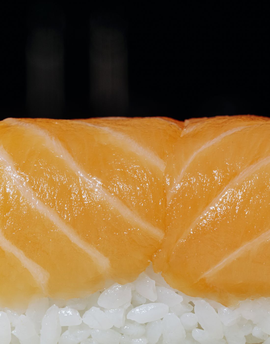 Detailed photo of fresh salmon nigiri, highlighting vibrant colors and texture.