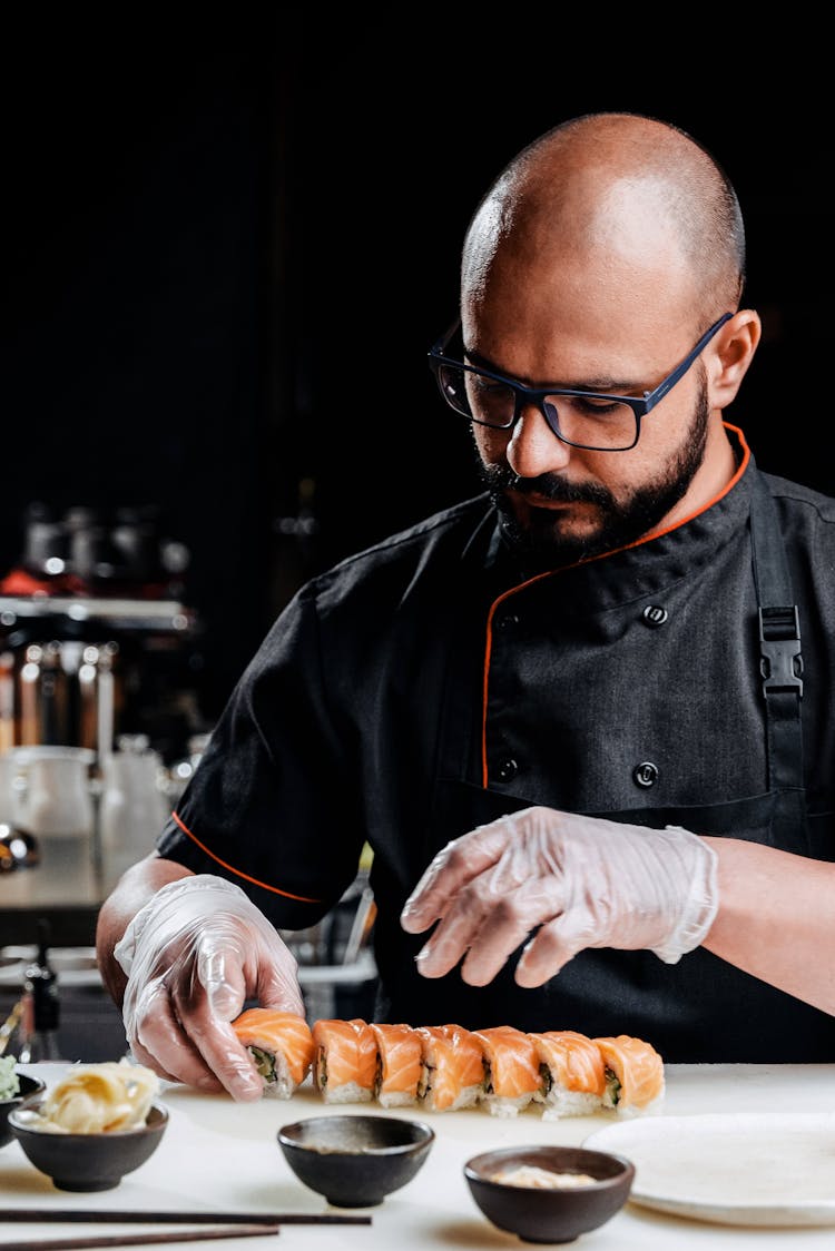 A Male Chef Making A Sushi