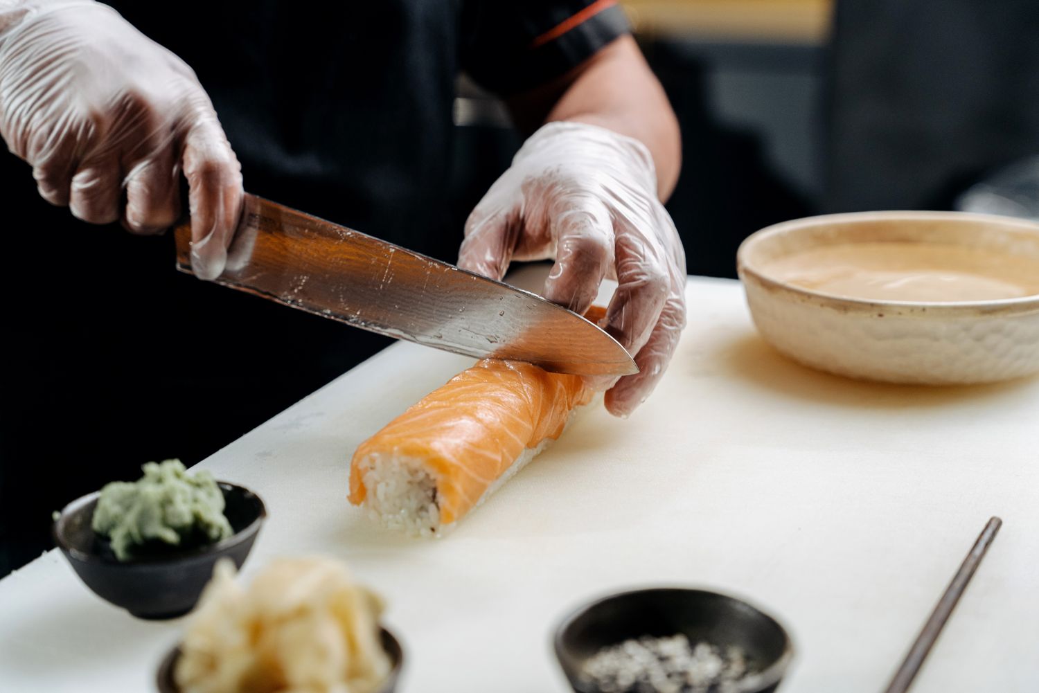 Chef slicing fish with a sushi knife