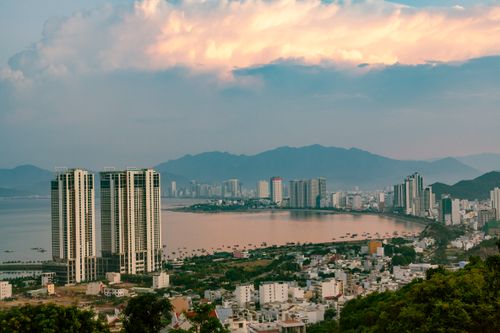 Free A breathtaking aerial view of a city skyline with high-rises and waterfront at sunrise. Stock Photo