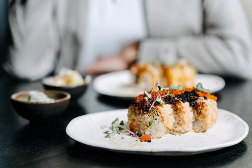 Garnished Sushi Rolls on a Ceramic Plate
