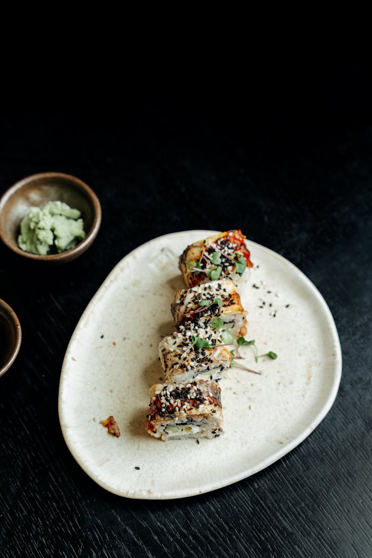 A Plate Of Sushi And Wasabi On A Bowl