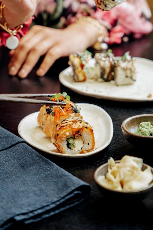 Sushi Rolls on White Ceramic Plates