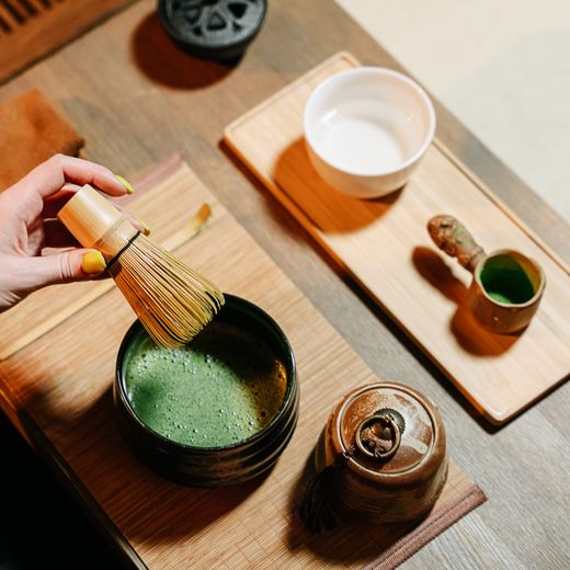 Matcha whisk, scoop and bowl on a wooden table — photo by Ivan S on Pexels