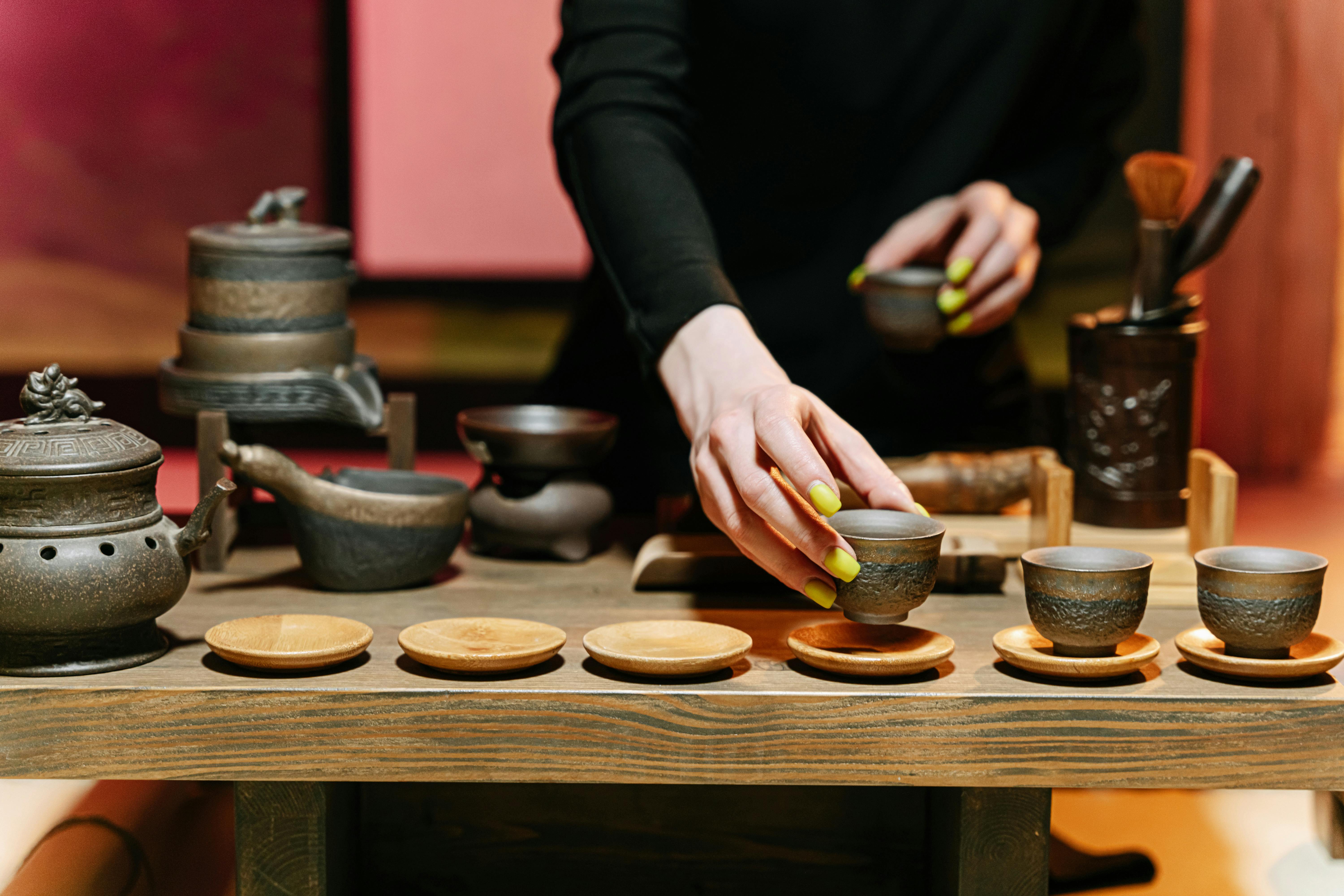 person holding a ceramic teacup