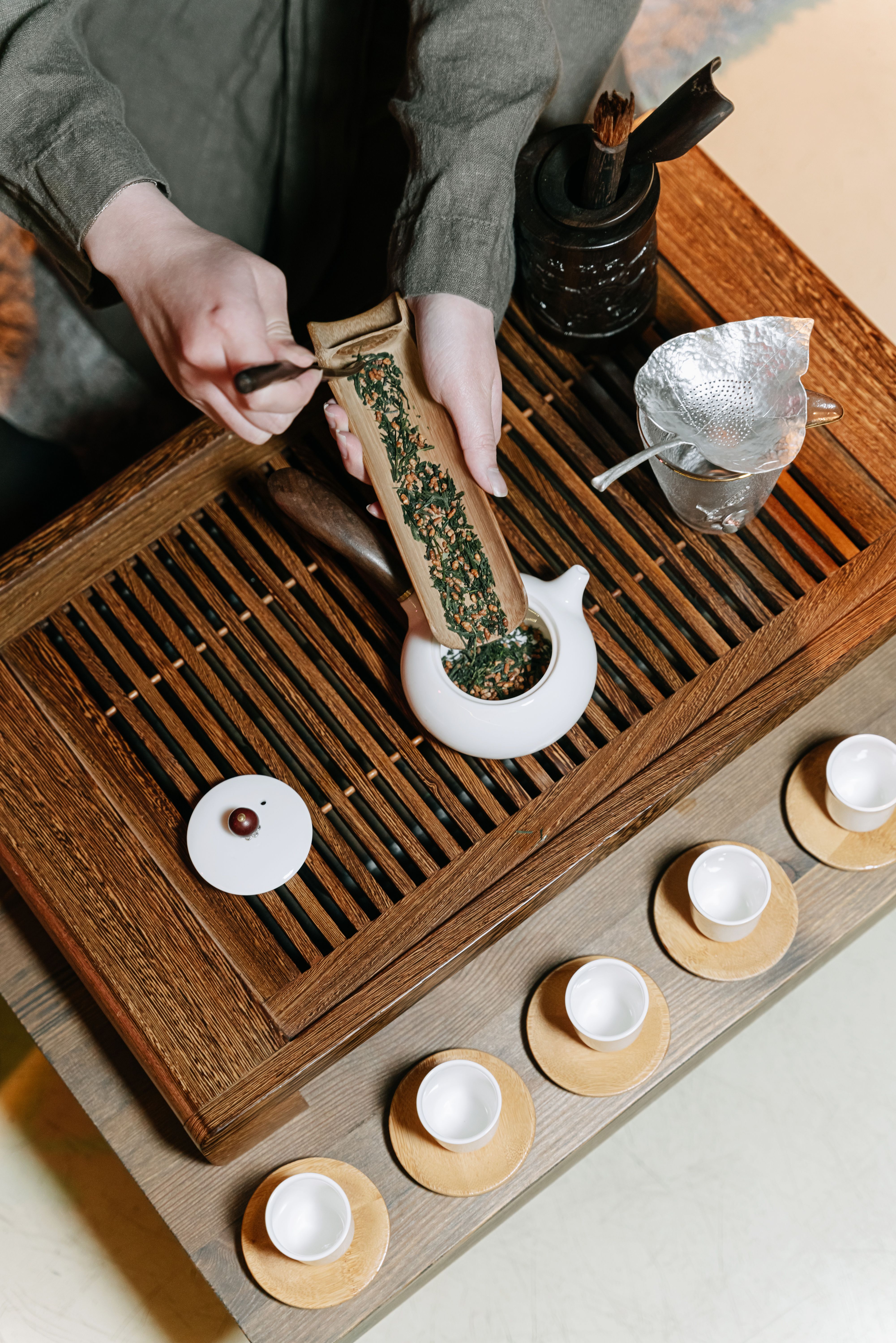 Person Putting Tea Leaves on a Teapot · Free Stock Photo