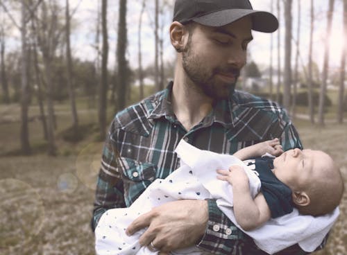 Free Man Holding Baby during Daytime Stock Photo
