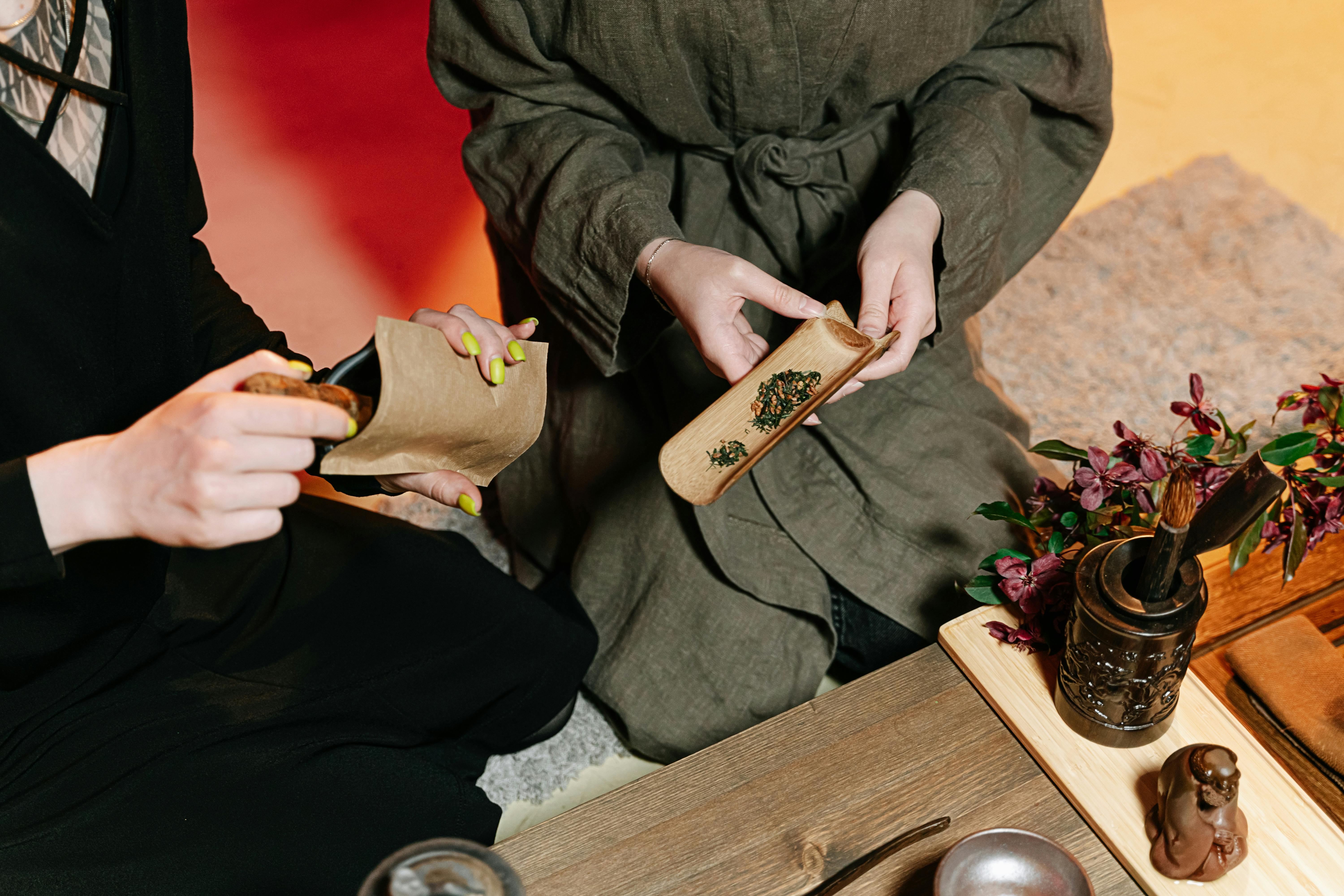 putting tea leaves on a piece of bamboo