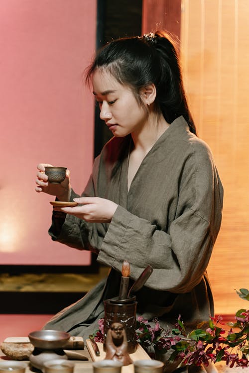 Woman Looking at the Teacup she is Holding