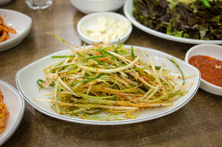 Green Onion Salad On White Ceramic Plate