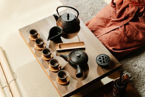 Free A serene setup of a traditional tea ceremony featuring rustic teapots and cups on a wooden table. Stock Photo