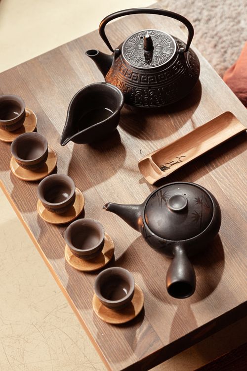 Free Close-up of a traditional tea ceremony setup with teacups and teapots on a wooden table, capturing a classic cultural moment. Stock Photo