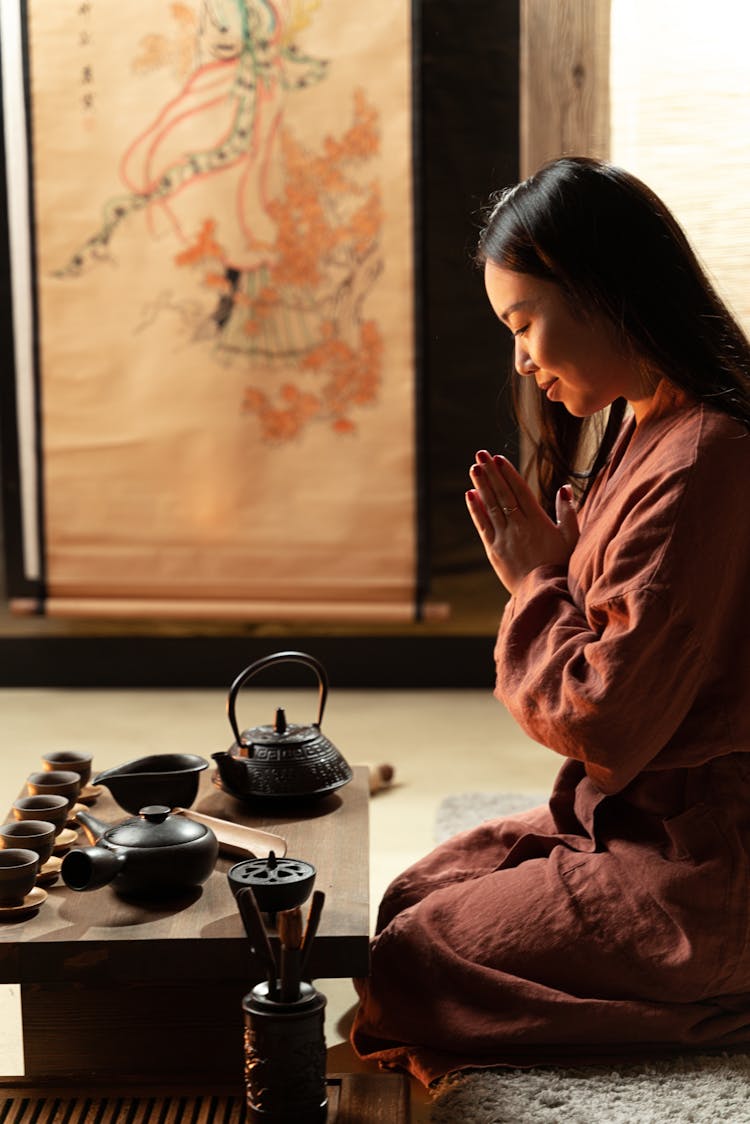 A Woman Wearing A Robe Performing A Tea Ceremony