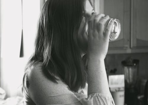 Free Grayscale Photo of Lady Drinking Water Stock Photo