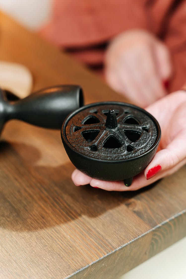 Woman Hand Holding Black Item