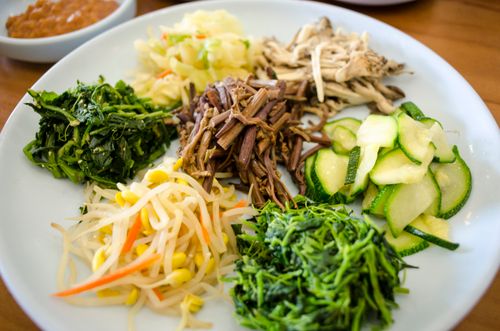 Free A vibrant assortment of traditional Korean side dishes including vegetables and bean sprouts. Stock Photo