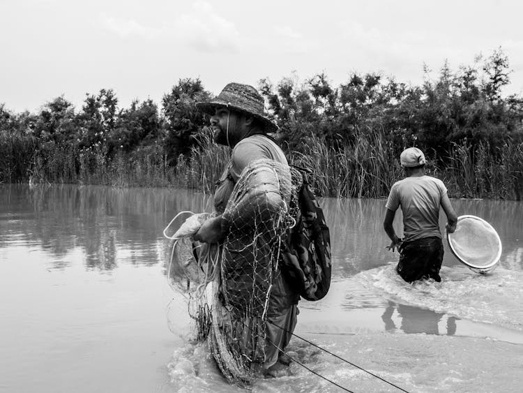 Men Fishing In River