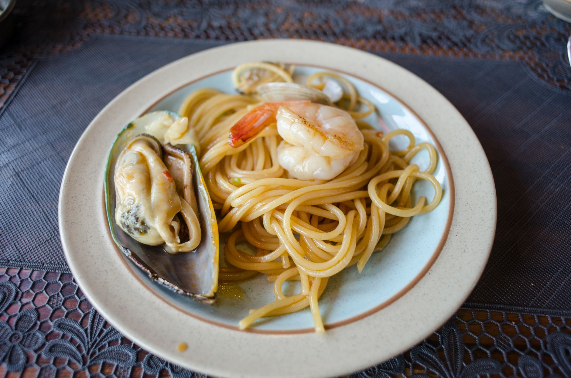 coastal Italian terrace lunch table with seafood and white wine