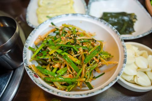 Free A vibrant and spicy Asian side dish of seasoned vegetables in a white bowl. Stock Photo