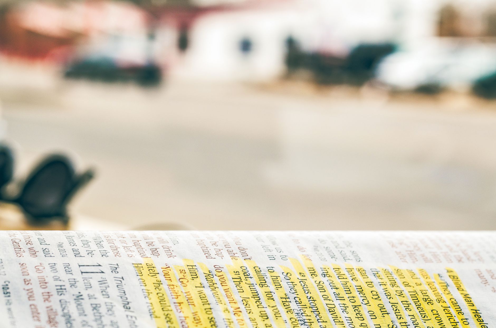 A person using a marker to highlight text in a notebook.